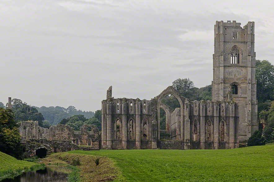 A substantial structure with a tall tower and an adjoining bridge, showcasing architectural design